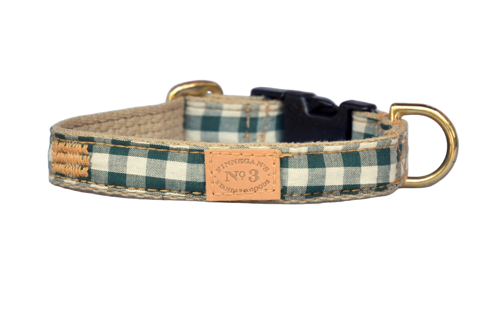 Dog collar with plaid pattern and brass hardware on a white background