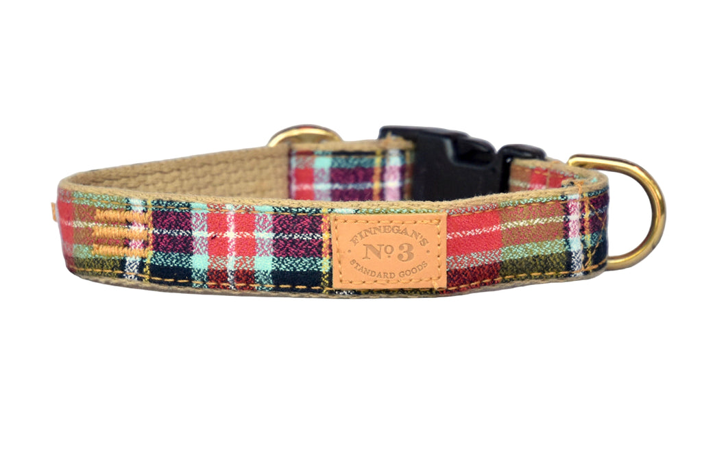 Plaid dog collar with a leather tag on a gray background