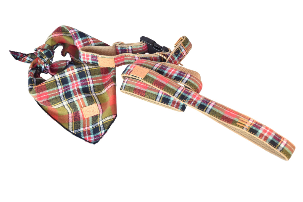 Plaid dog harness and bandana set on a light wooden surface